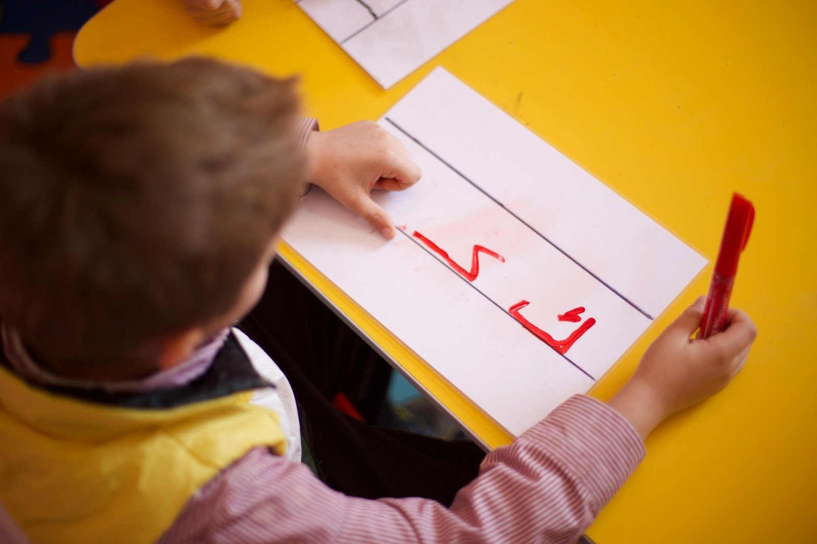 Fine motor skills dyslexia challenges shown by incorrect pencil grip.